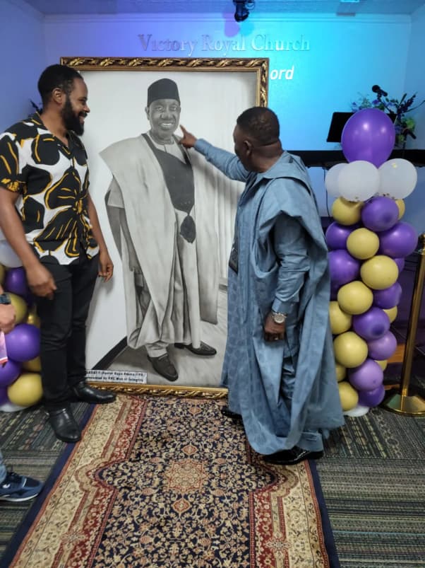 Pastor Bayo with family and friends at a church gathering
